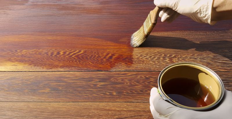 Applying stain to a deck